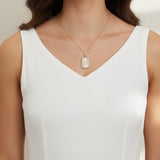 love pendant necklace on model, gold tag necklace lifestyle, sunburst pendant necklace worn, pavé love necklace styled, engraved love pendant on neck, long chain pendant necklace, statement gold necklace, script love necklace outfit