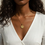 gold wishbone necklace, compass coin pendant necklace, medallion necklace gold, symbolic jewelry, vintage coin necklace, textured gold necklace, lucky charm necklace, layering necklace