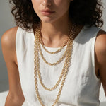 faceted cable chain necklace, layered gold chains, gold cable chain set, graduated length necklaces, oval link chain necklace, layering chain necklaces, everyday gold chain stack, link chain detail