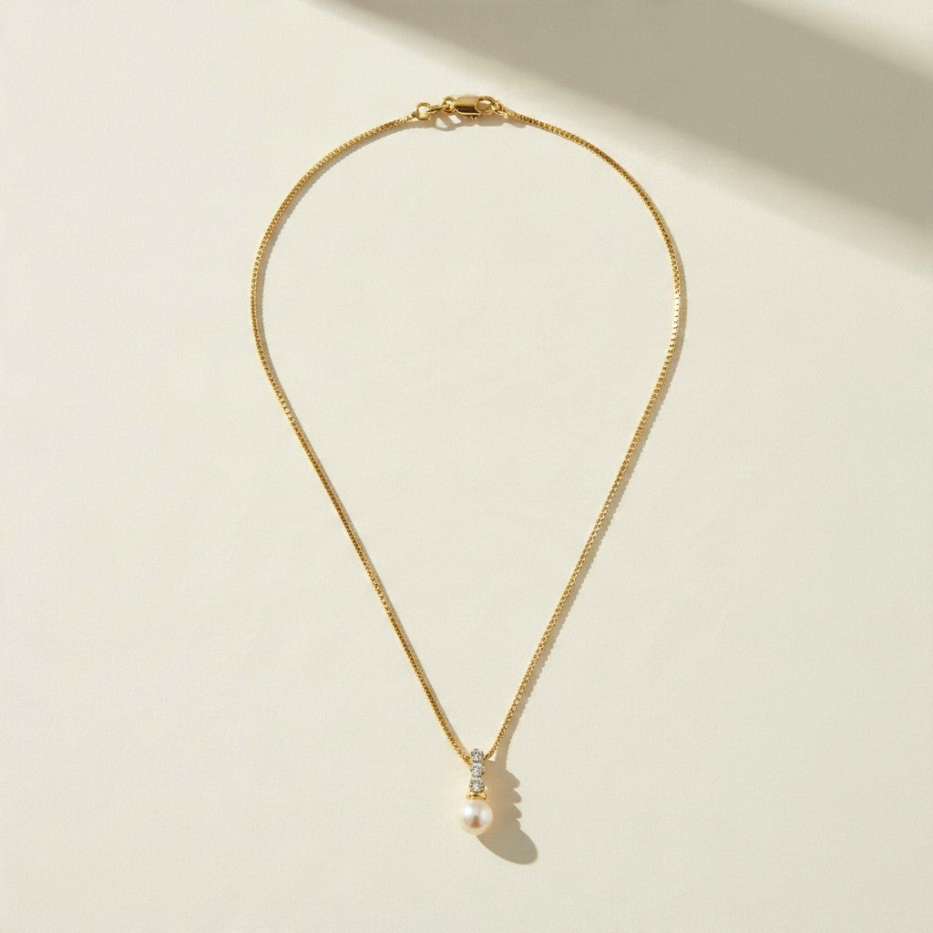 pearl pendant necklace, pearl drop necklace, gold box chain necklace, pearl and crystal necklace, dainty pearl necklace, bridal pearl necklace, classic pearl pendant, gold chain pearl necklace, cubic zirconia pearl pendant, elegant pearl necklace, wedding necklace, women’s pearl pendant necklace