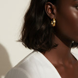 hammered gold hoop earrings, textured hoop earrings, gold huggie hoops, everyday gold earrings, small gold hoops, organic texture earrings, minimalist gold jewelry, on-model earring photography