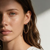 gold hoop earrings on model, textured gold hoops, thin endless hoop earrings, diamond-cut hoop earrings, lightweight hoop earrings, medium gold hoops, minimalist gold hoops, everyday hoop earrings, sleeper hoops, twist hoop earrings, women’s gold hoops, elegant everyday earrings